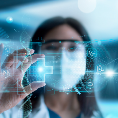 Image of a female scientist holding a light blue medical cross.